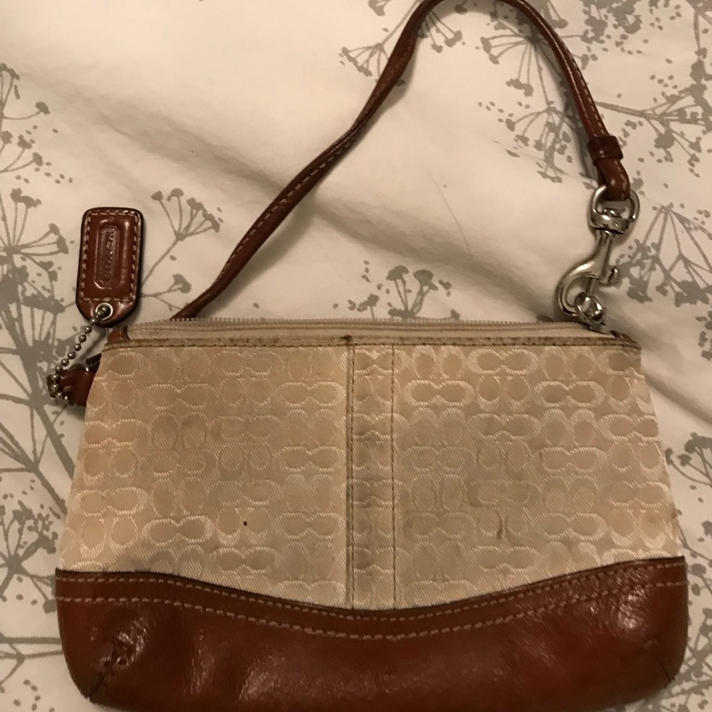Cream and tan Coach wristlet